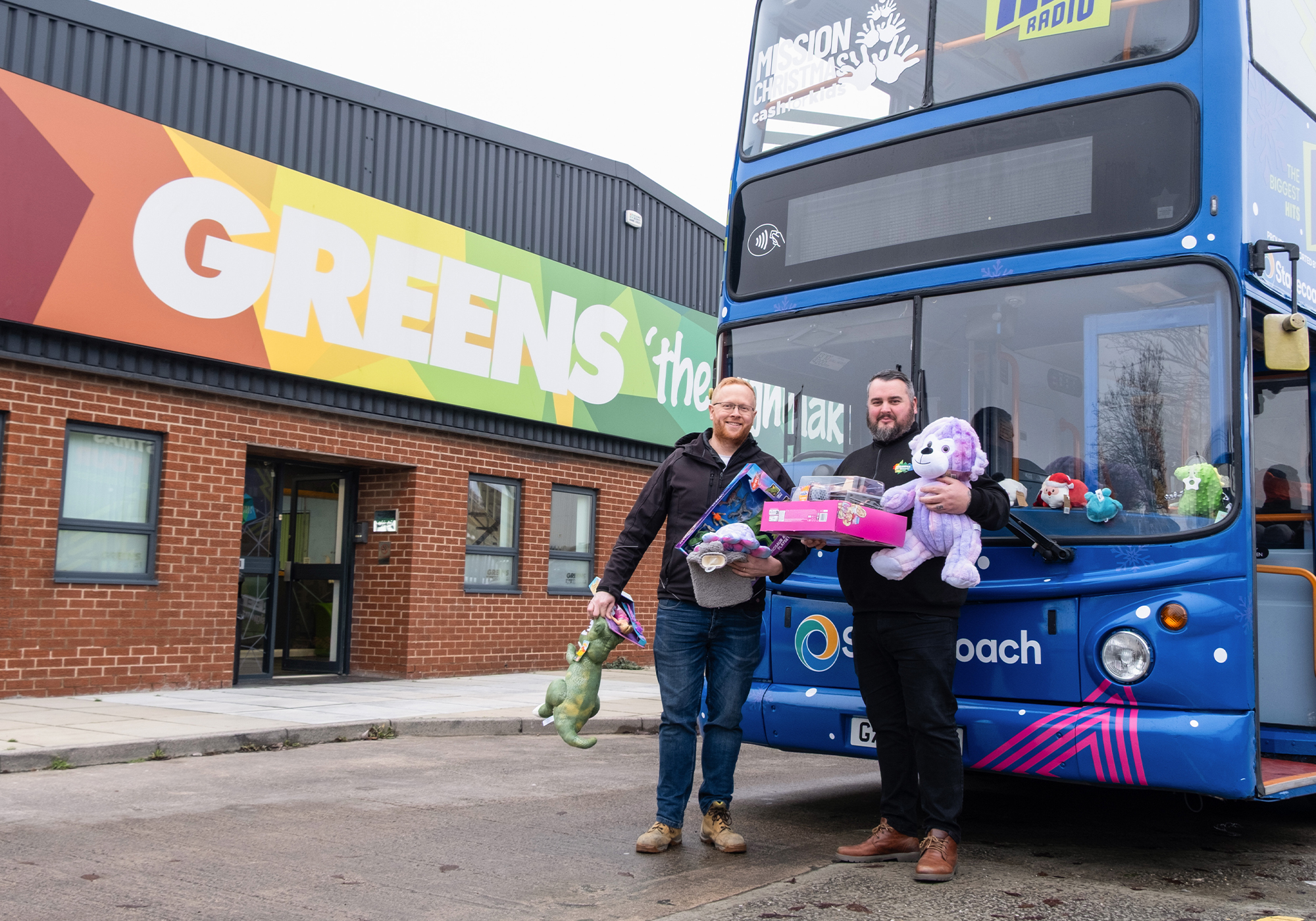 Lawrence and Mark in front of the Cash for Kids bus outside Greens.